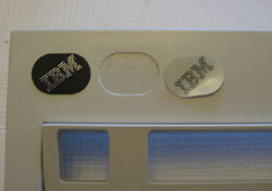 Black metal trackpoint logo on the left, white plastic 1391401 logo on the right